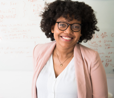 Woman with a pink blazer smiling 