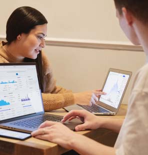 male and female looking at laptop screen