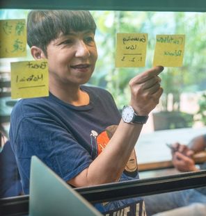 woman looking at sticky notes on window