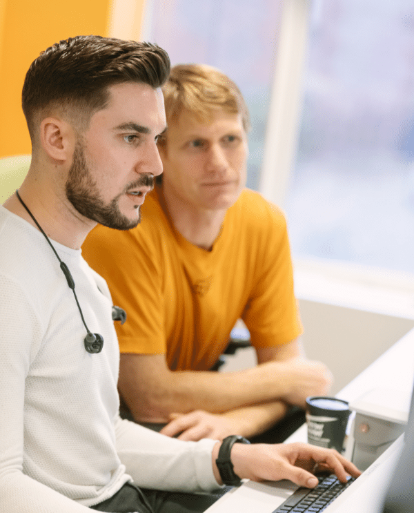 Two males working together on a computer
