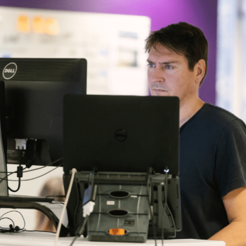 Serious male working on computer