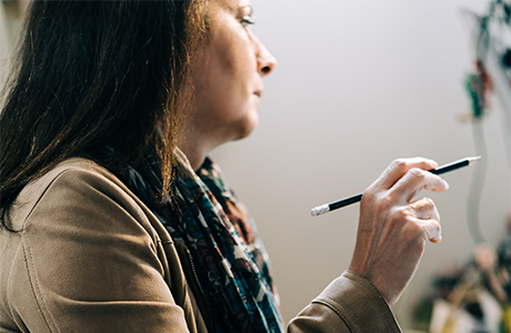 Woman holding a pencil 