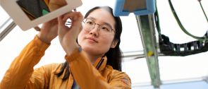 Woman working on engineering device.