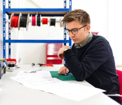 Man sitting at a table looking at an analysis