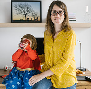 Woman holding her children sitting on a table