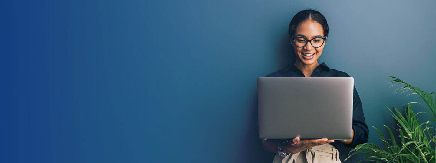 Woman sitting looking at her laptop