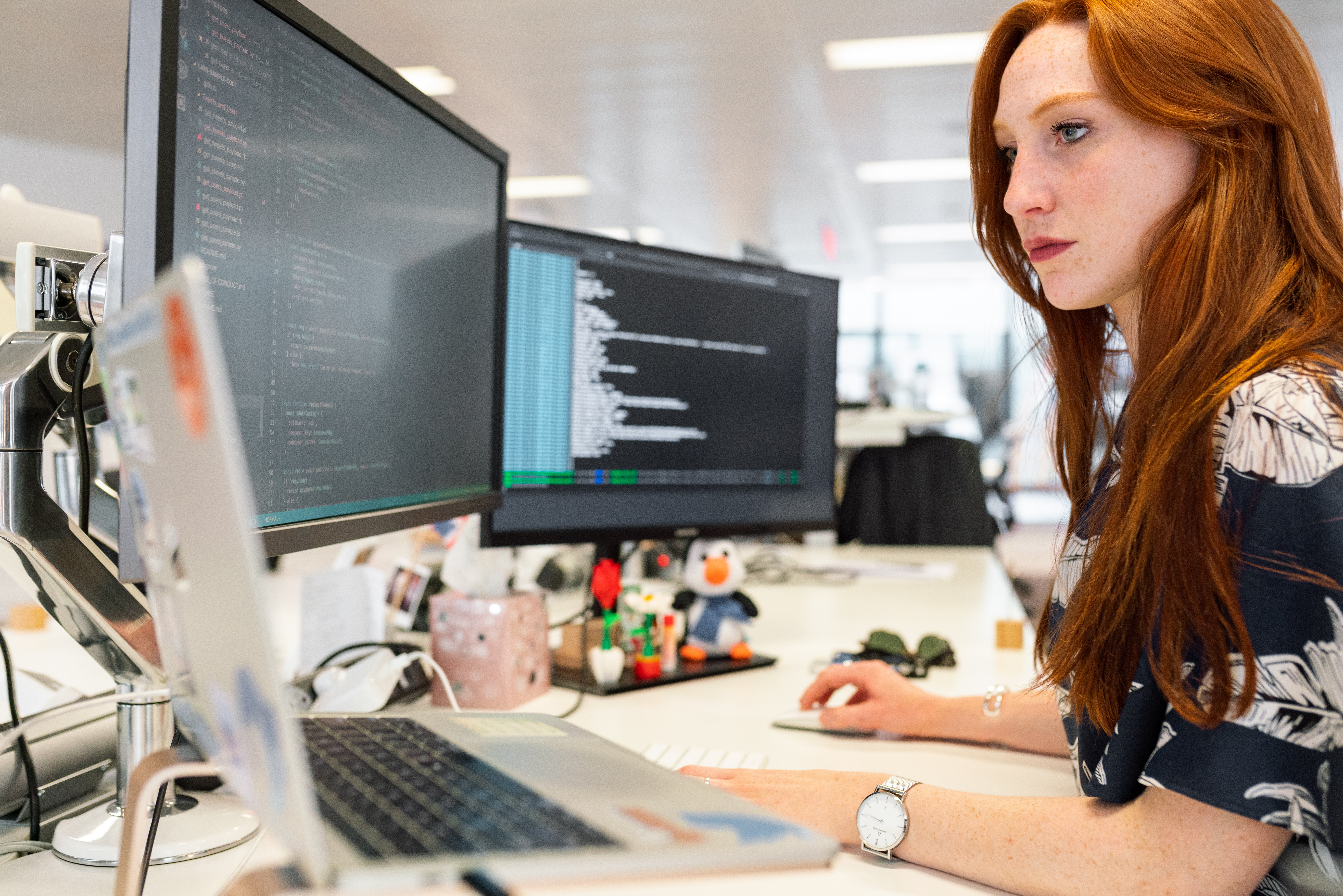 woman in green shirt sitting in front of computer photo